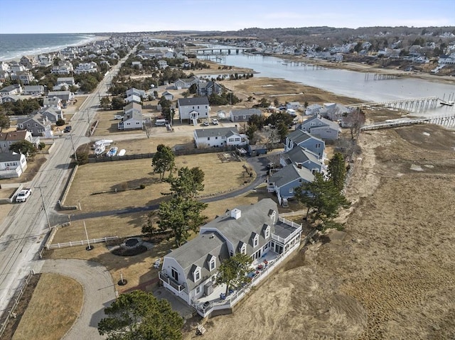 drone / aerial view with a residential view and a water view