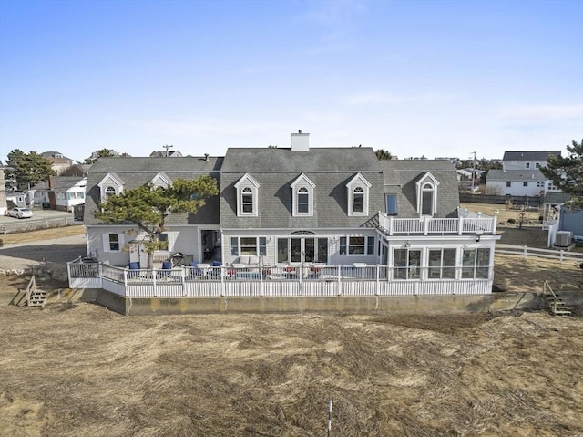 back of property featuring a patio, fence, and a chimney