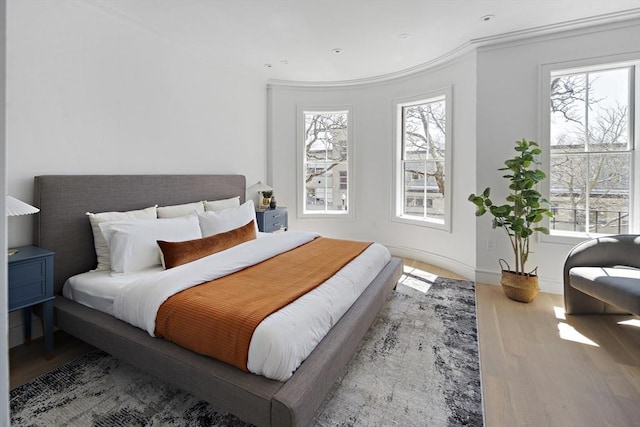 bedroom featuring hardwood / wood-style floors and crown molding