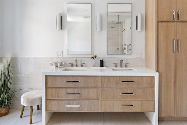 bathroom featuring tile walls, walk in shower, and vanity