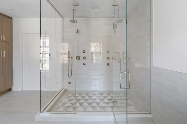 bathroom with a shower with door