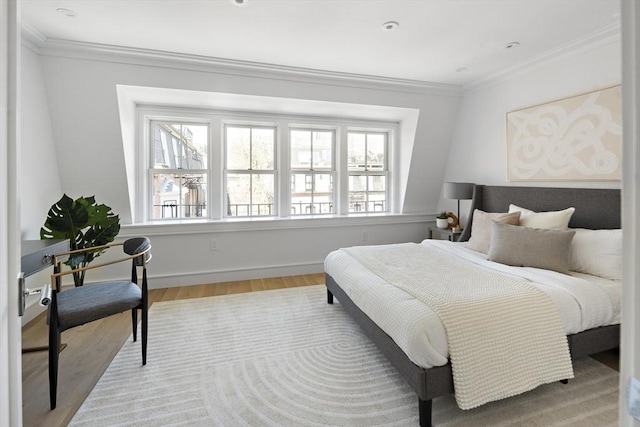 bedroom with light hardwood / wood-style flooring and crown molding