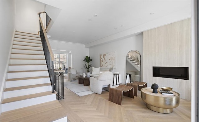 living room with light parquet flooring and ornamental molding