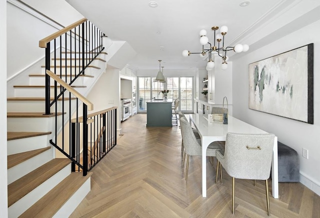 dining room with parquet floors and an inviting chandelier