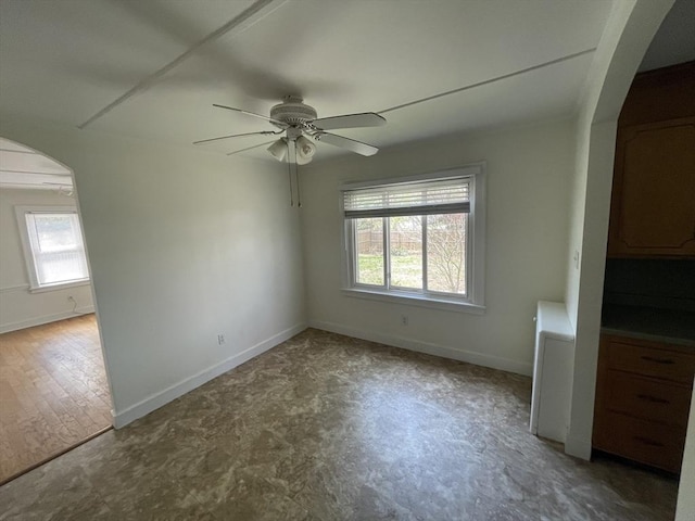3 Camden St, South Hadley, MA 01075 - empty room featuring arched walkways, ceiling fan, and baseboards