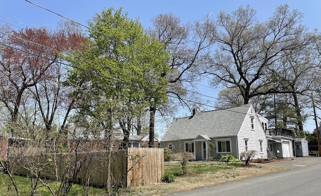 3 Camden St, South Hadley, MA 01075 - view of home's exterior with fence, a chimney, and roof with shingles