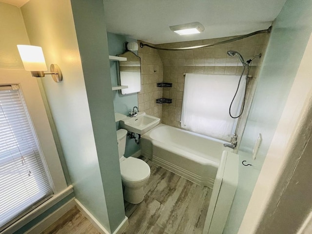 3 Camden St, South Hadley, MA 01075 - bathroom with washtub / shower combination, a sink, toilet, baseboards, and wood finished floors