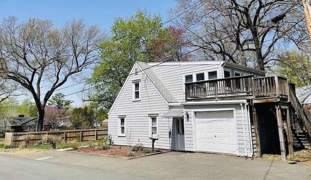 3 Camden St, South Hadley, MA 01075 - view of front facade featuring a garage, fence, a deck, driveway, and stairway