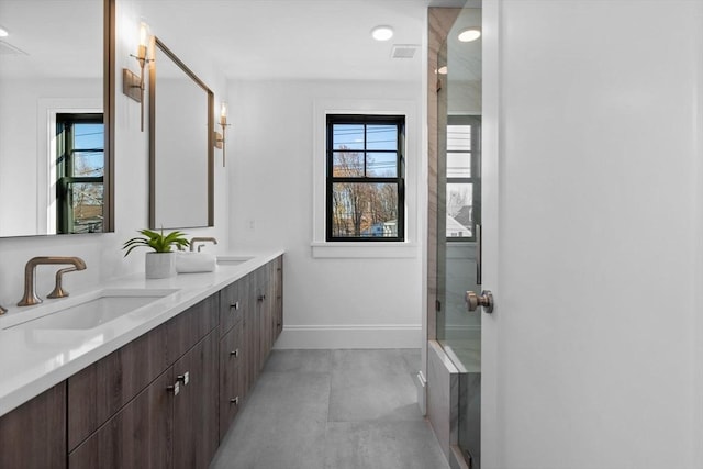 bathroom with walk in shower and vanity