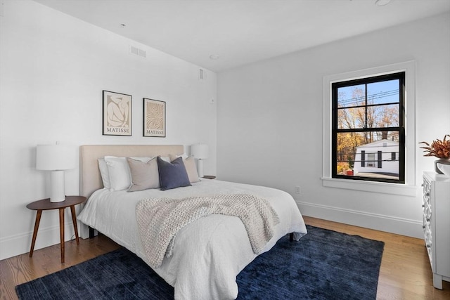 bedroom with wood-type flooring