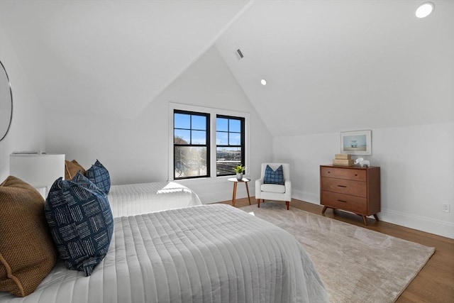 bedroom featuring lofted ceiling and hardwood / wood-style floors