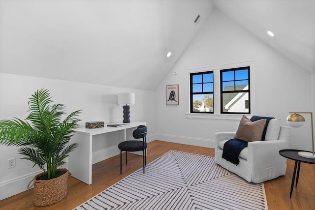 office with light hardwood / wood-style flooring and vaulted ceiling