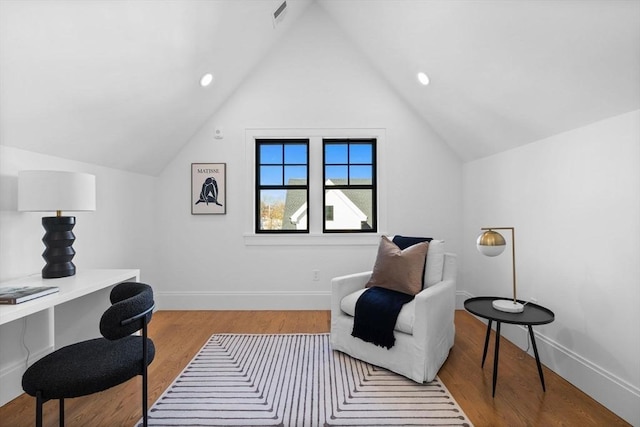 office featuring light wood-type flooring, lofted ceiling, and built in desk