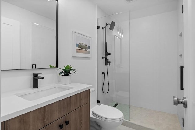 bathroom with toilet, vanity, and walk in shower