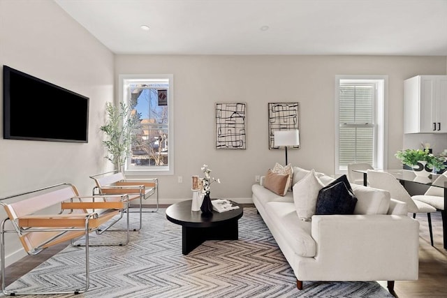 living area featuring light wood-style floors and baseboards