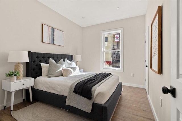 bedroom featuring baseboards and wood finished floors