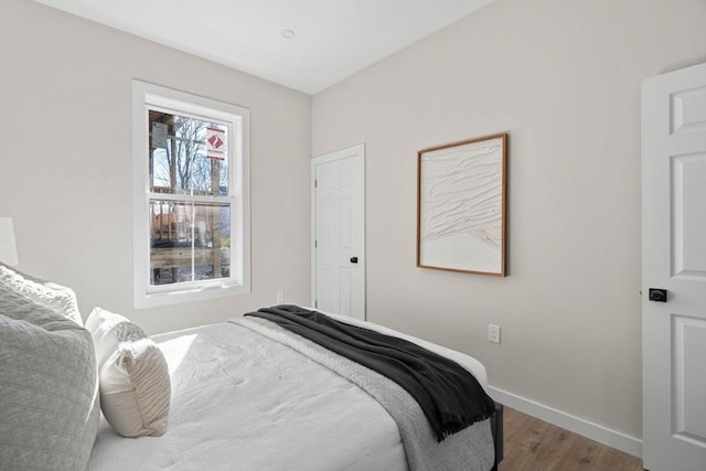 bedroom featuring wood finished floors and baseboards