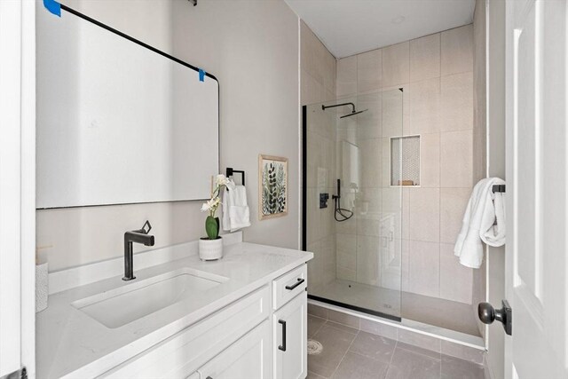 bathroom featuring vanity, a stall shower, and tile patterned flooring