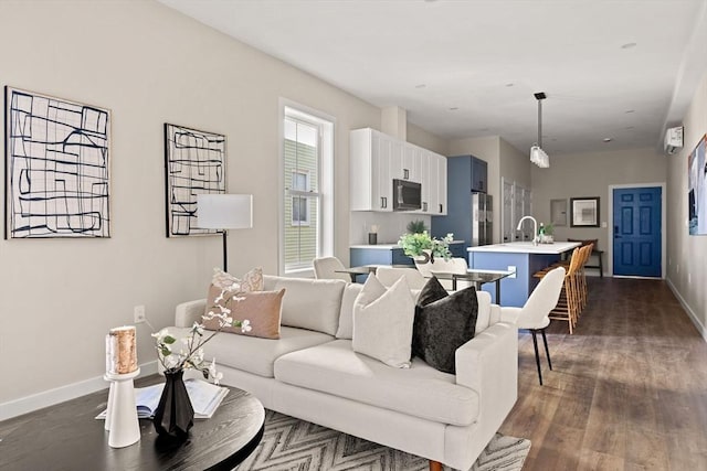 living room featuring baseboards and dark wood-type flooring