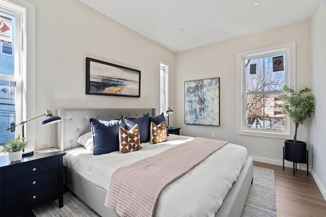 bedroom featuring baseboards and wood finished floors