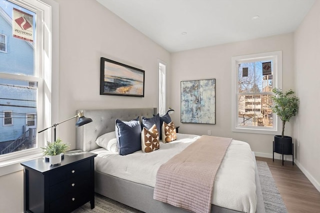 bedroom with baseboards and wood finished floors