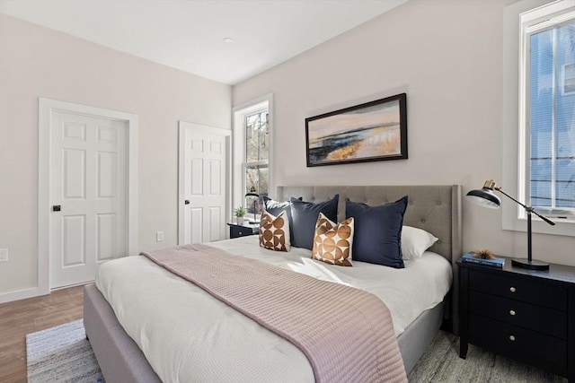 bedroom with wood finished floors and baseboards