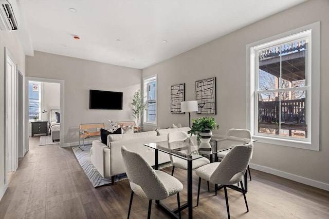 dining room featuring baseboards and light wood-style flooring