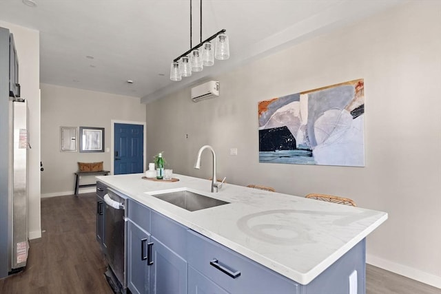 kitchen featuring dark wood-type flooring, a wall mounted air conditioner, appliances with stainless steel finishes, hanging light fixtures, and a sink