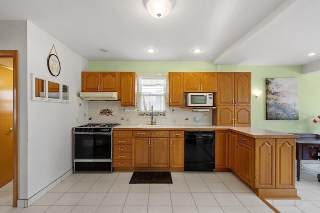 kitchen featuring white microwave, under cabinet range hood, black dishwasher, backsplash, and gas range