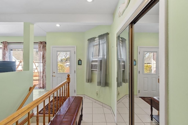 hall with recessed lighting, an upstairs landing, and light tile patterned floors