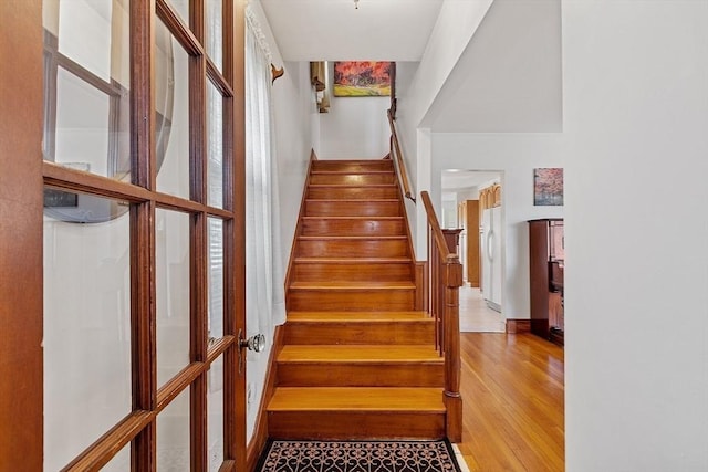 stairs featuring baseboards and wood finished floors