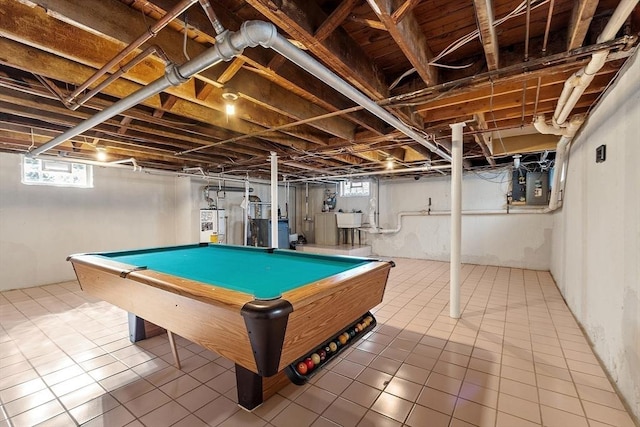 rec room featuring plenty of natural light, electric panel, a sink, and water heater