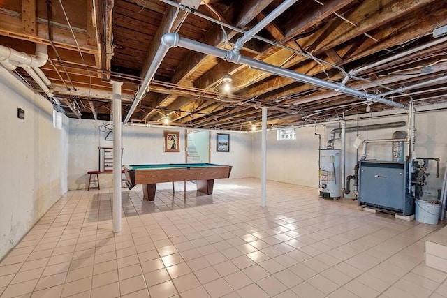 basement with billiards, a heating unit, stairway, tile patterned floors, and water heater