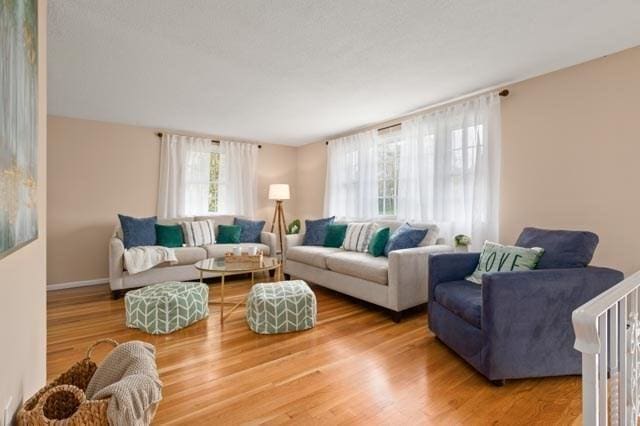 living area with light wood finished floors and baseboards