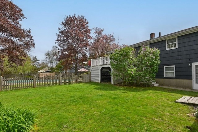view of yard with a wooden deck and a fenced backyard