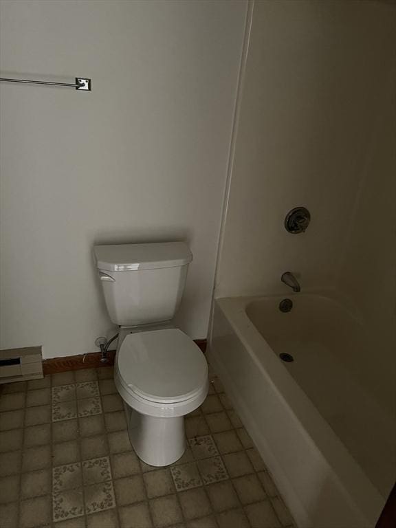 bathroom with toilet, baseboards, and shower / bathing tub combination