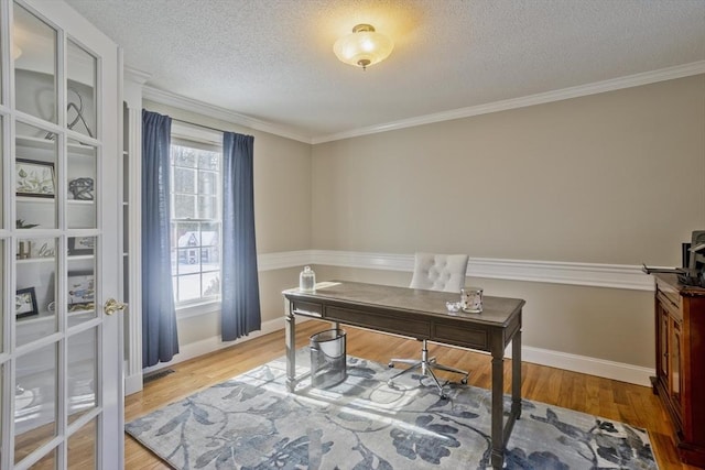 home office featuring wood finished floors, visible vents, baseboards, ornamental molding, and a textured ceiling