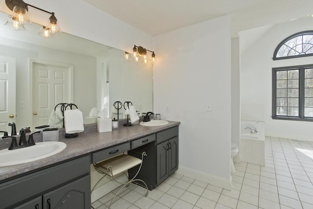 full bath featuring tile patterned floors, a garden tub, double vanity, and a sink