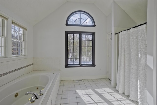 full bathroom featuring baseboards, lofted ceiling, a jetted tub, and tile patterned flooring