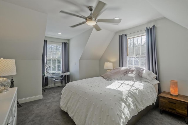 bedroom featuring vaulted ceiling, multiple windows, baseboards, and dark colored carpet