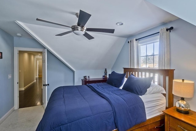 bedroom with dark wood finished floors, lofted ceiling, baseboards, and ceiling fan