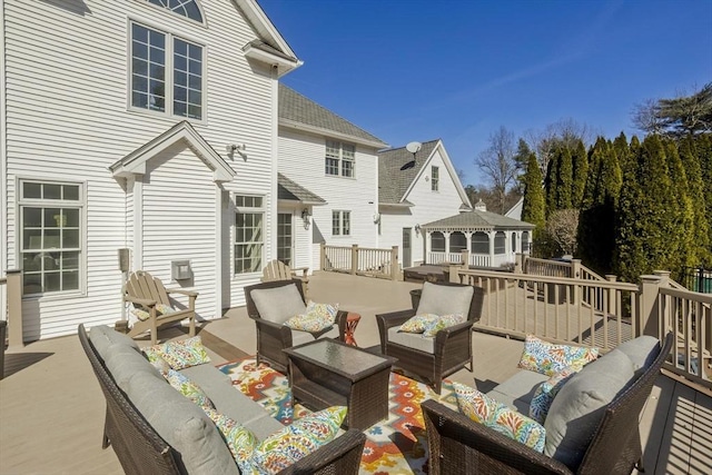 wooden terrace with a gazebo and outdoor lounge area