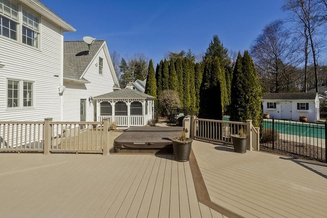 wooden terrace featuring a gazebo and an outdoor structure