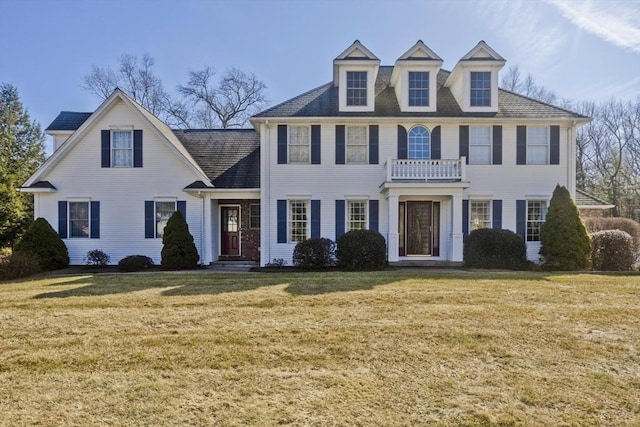 georgian-style home with a front lawn