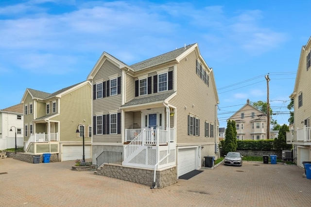 224 Grove St Unit 2, Waltham, MA 02453 - view of front of house with decorative driveway and a garage