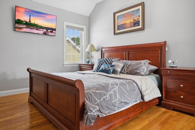 224 Grove St Unit 2, Waltham, MA 02453 - bedroom featuring wood finished floors and vaulted ceiling