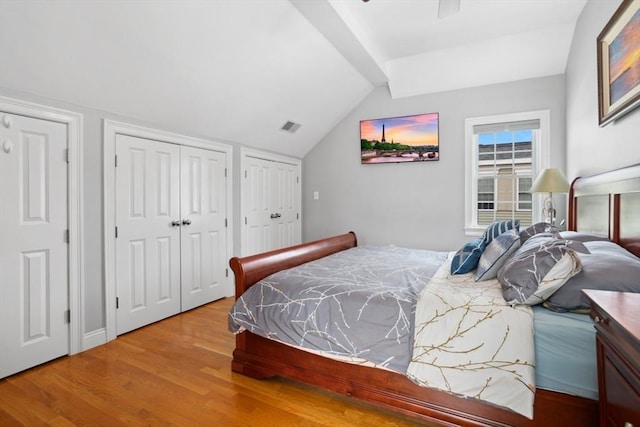 224 Grove St Unit 2, Waltham, MA 02453 - bedroom with two closets, wood finished floors, and lofted ceiling