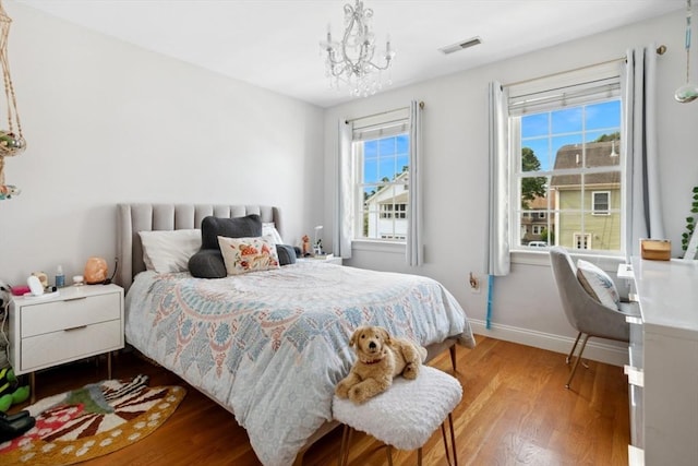 224 Grove St Unit 2, Waltham, MA 02453 - bedroom featuring wood finished floors and a chandelier