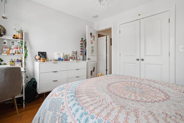 224 Grove St Unit 2, Waltham, MA 02453 - bedroom featuring dark wood-style flooring, a closet, and a chandelier