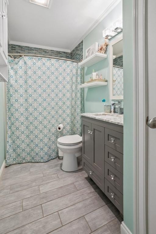 224 Grove St Unit 2, Waltham, MA 02453 - bathroom with crown molding, vanity, a shower with shower curtain, and wood tiled floors